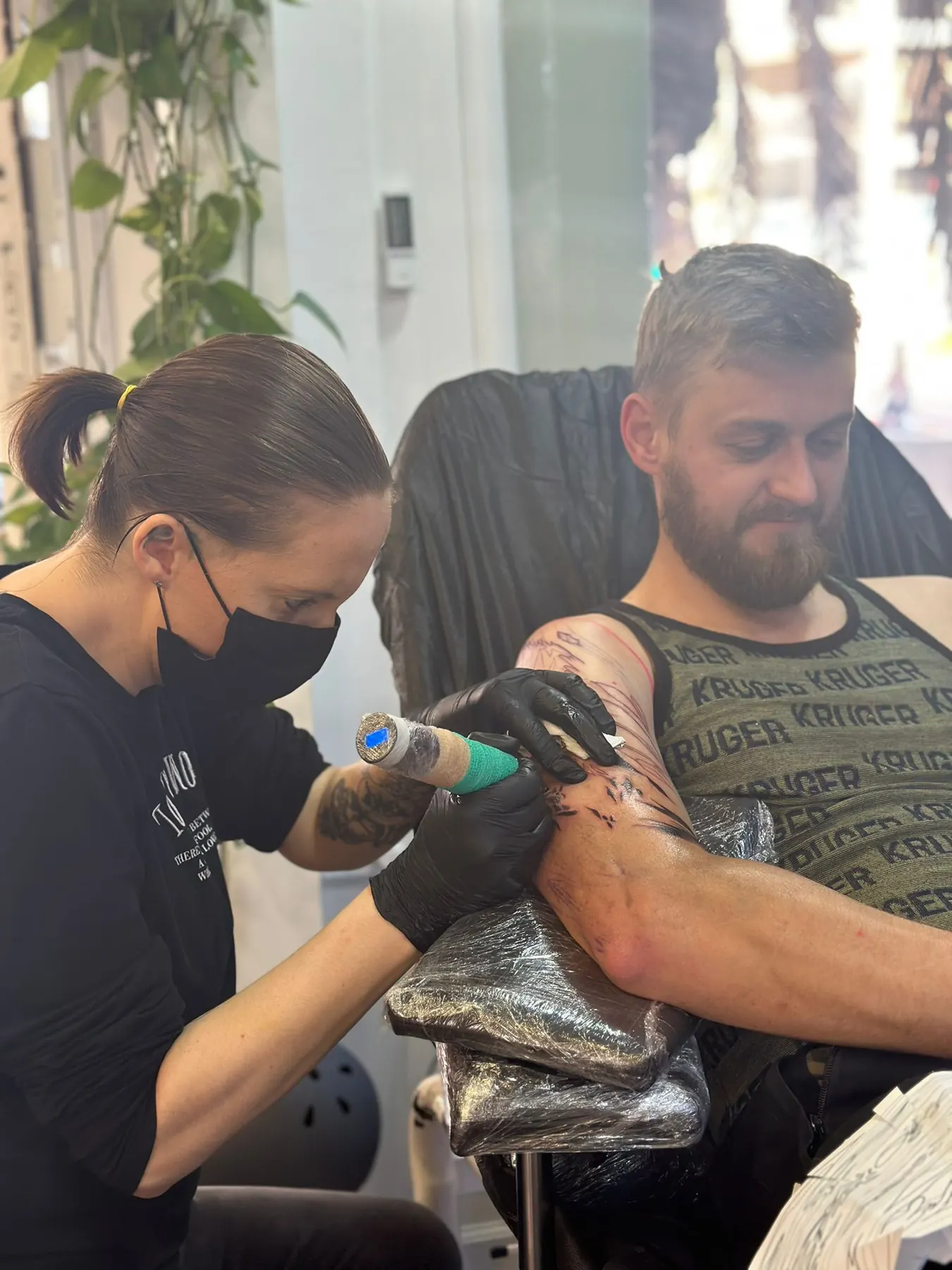 Lady Jane tattooing a client in the studio