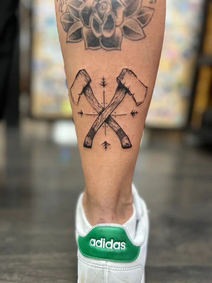 Crossed axes with arrows, vintage woodcut style calf tattoo