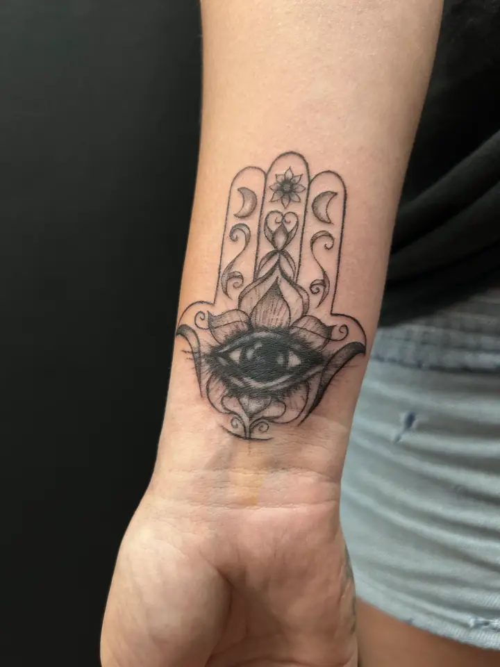 Hamsa with an all-seeing eye tattoo by Lady Jane